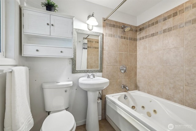 bathroom featuring a sink, toilet, and a combined bath / shower with jetted tub