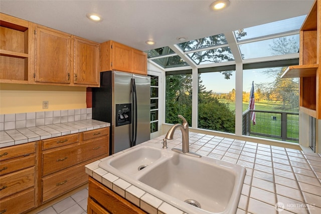 64 Garry Oak Ln, Friday Harbor, WA 98250 - kitchen featuring a sink, open shelves, stainless steel fridge, light tile patterned flooring, and tile counters