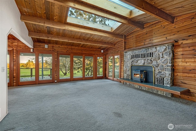 64 Garry Oak Ln, Friday Harbor, WA 98250 - unfurnished living room featuring lofted ceiling with skylight, carpet flooring, wood walls, and wooden ceiling