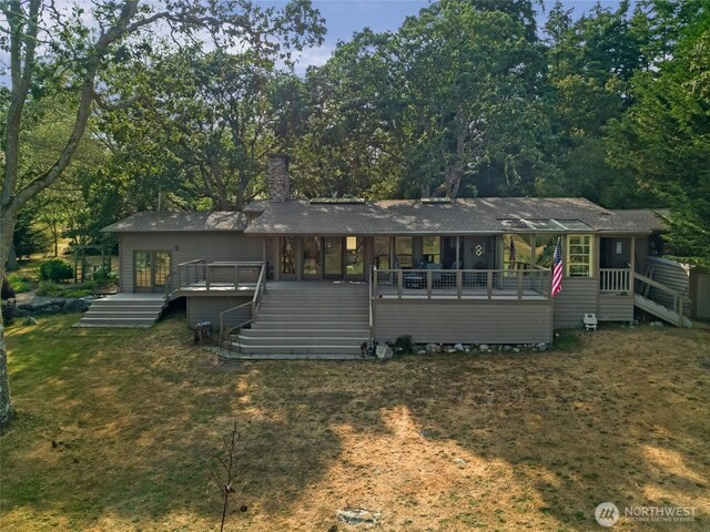 64 Garry Oak Ln, Friday Harbor, WA 98250 - rear view of house with a chimney, a wooden deck, stairs, and a sunroom