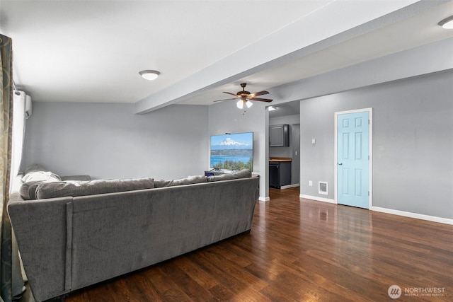 living area with visible vents, baseboards, a ceiling fan, wood finished floors, and beam ceiling