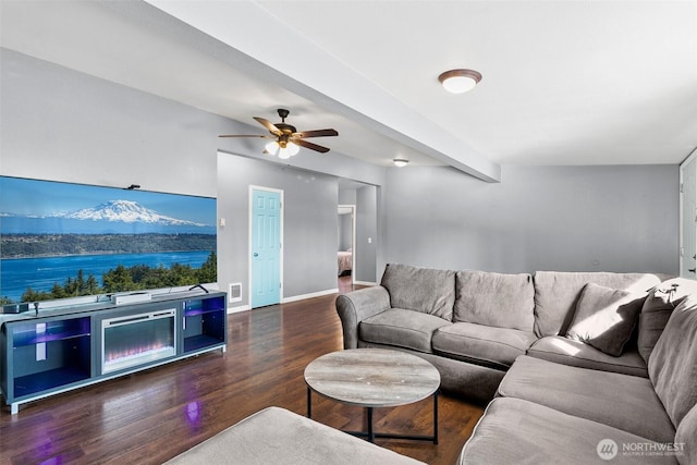 living room with beam ceiling, visible vents, ceiling fan, wood finished floors, and baseboards