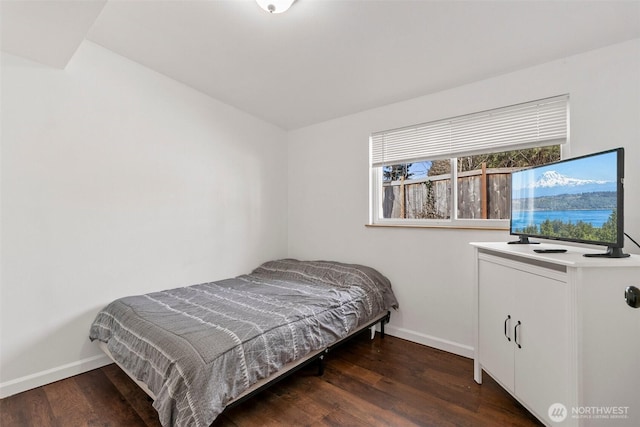 bedroom featuring baseboards and wood finished floors