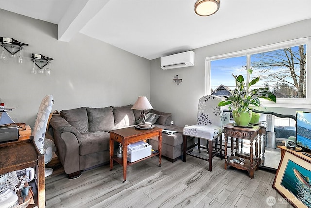 living room featuring light wood-style floors, a wall unit AC, and beamed ceiling