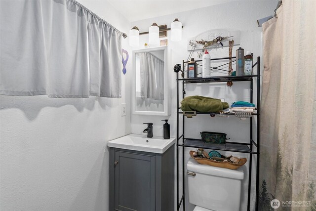 bathroom featuring vanity and toilet