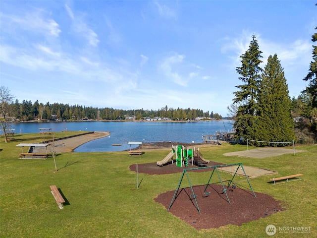 exterior space with a water view, a lawn, and playground community