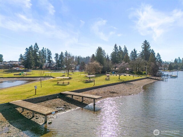 surrounding community with a yard and a water view