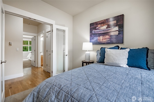 bedroom featuring baseboards and wood finished floors