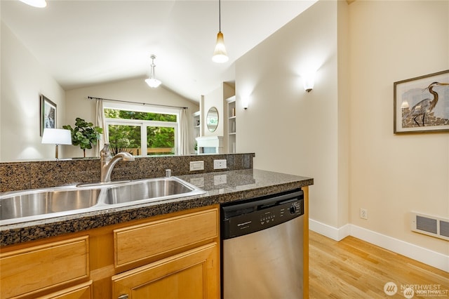 kitchen featuring tile counters, lofted ceiling, visible vents, a sink, and dishwasher