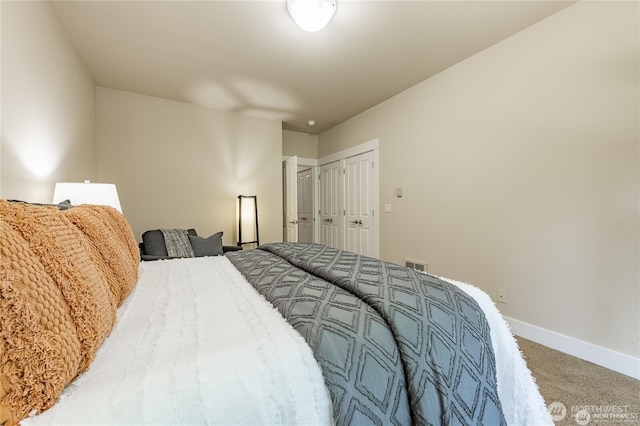 bedroom featuring carpet flooring, visible vents, and baseboards