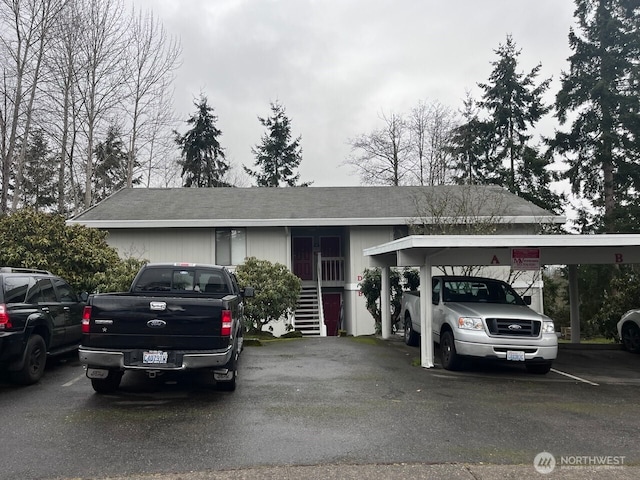 ranch-style house featuring covered and uncovered parking