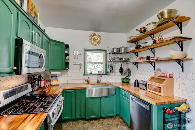 kitchen featuring tasteful backsplash, wooden counters, open shelves, stainless steel appliances, and a sink