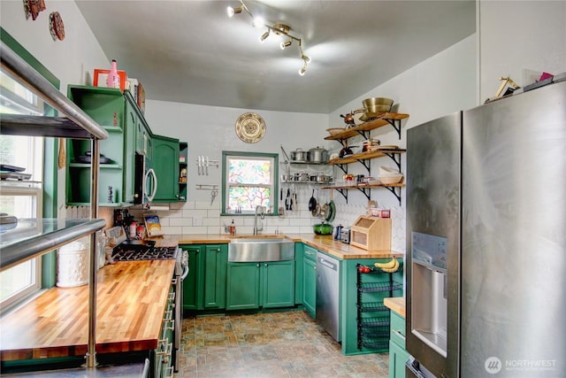 kitchen featuring open shelves, wood counters, and green cabinetry