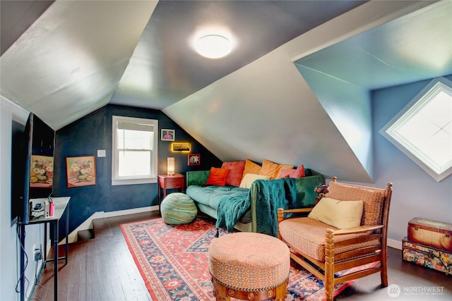 sitting room featuring hardwood / wood-style flooring, baseboards, and vaulted ceiling