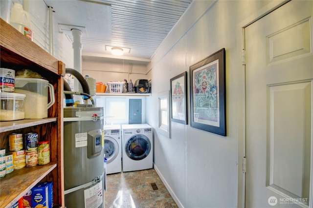 laundry room with baseboards, independent washer and dryer, laundry area, and stone finish floor