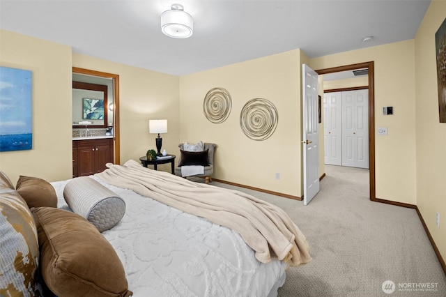 bedroom featuring a sink, baseboards, light carpet, and visible vents