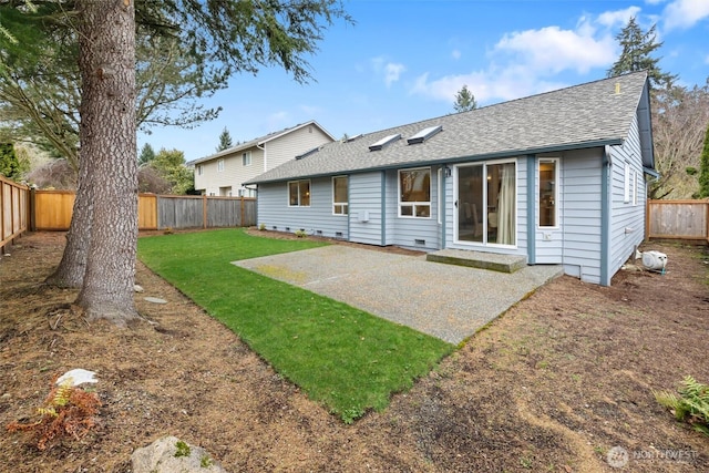 rear view of property featuring a patio, a fenced backyard, a lawn, and a shingled roof