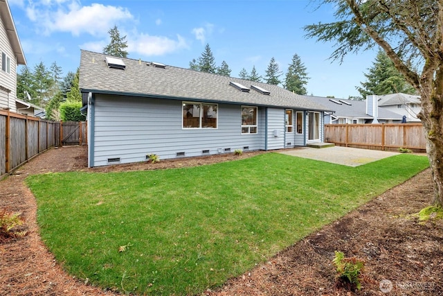 back of house featuring a patio, a fenced backyard, a yard, a shingled roof, and crawl space