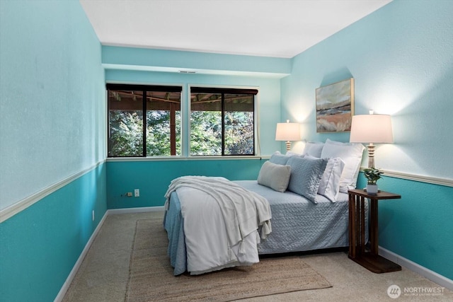 carpeted bedroom with baseboards