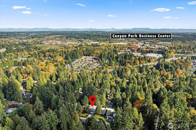 birds eye view of property featuring a mountain view and a forest view