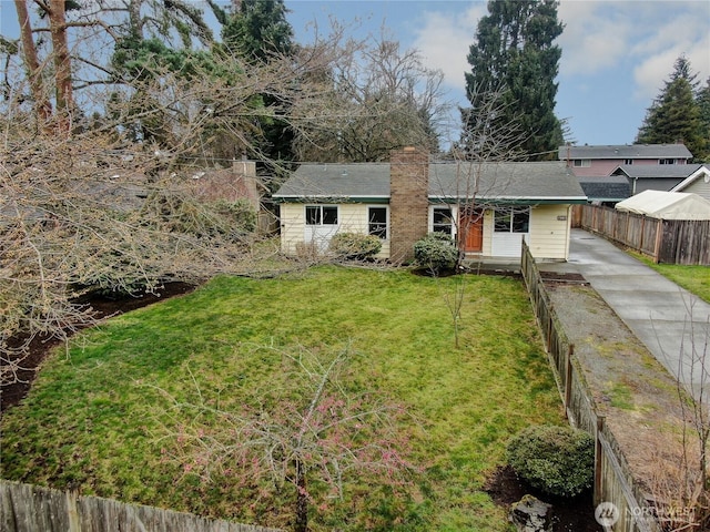 ranch-style house with a chimney, a front yard, and fence