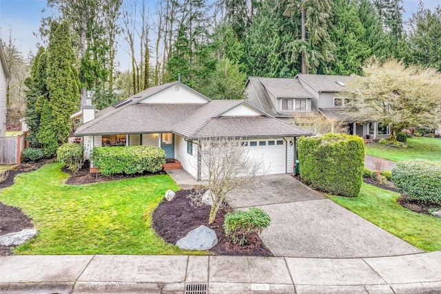 view of front of property with a garage, driveway, a front lawn, and a shingled roof