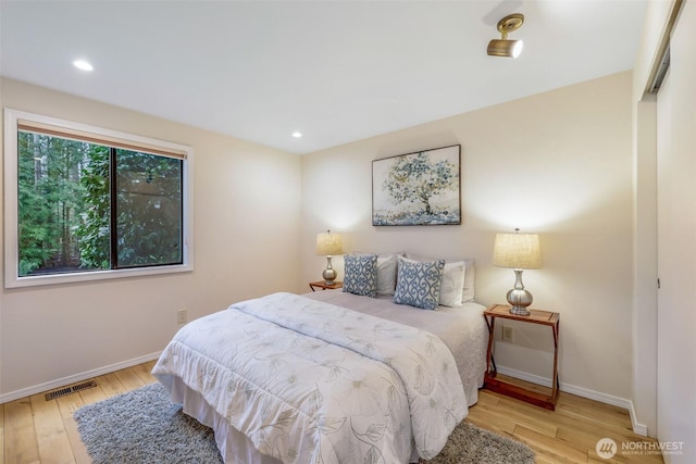 bedroom featuring visible vents, recessed lighting, baseboards, and wood finished floors