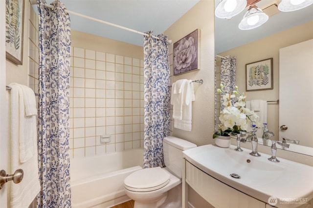 bathroom featuring vanity, shower / bath combination with curtain, and toilet