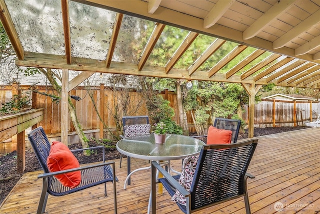 deck with a fenced backyard and outdoor dining space