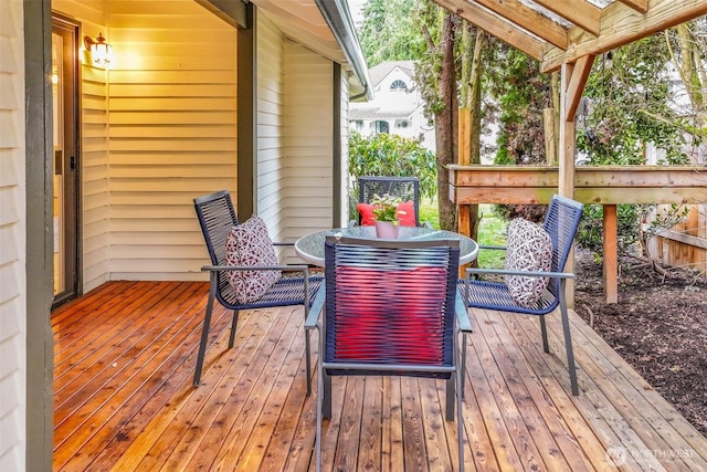 wooden terrace with outdoor dining area