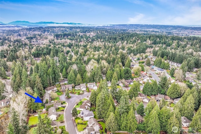 aerial view featuring a mountain view and a view of trees