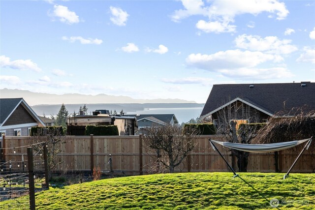 view of yard with a mountain view and fence