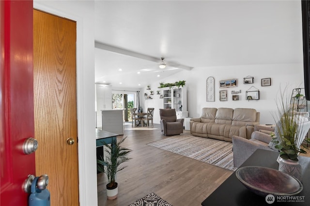 living room with wood finished floors and vaulted ceiling with beams