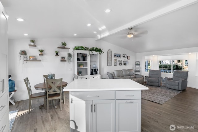 kitchen with recessed lighting, wood finished floors, vaulted ceiling with beams, and light countertops