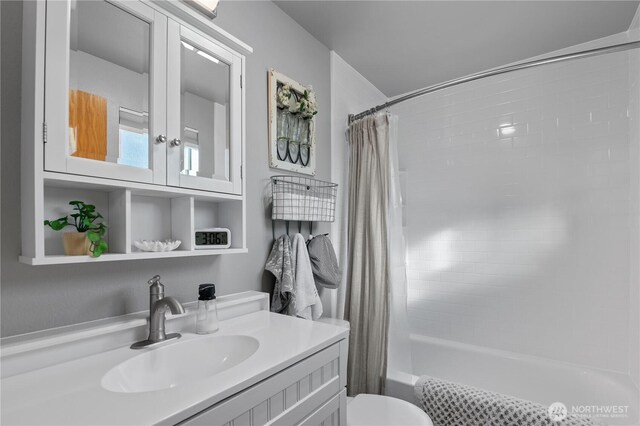 full bath featuring vanity, toilet, and shower / bathtub combination with curtain