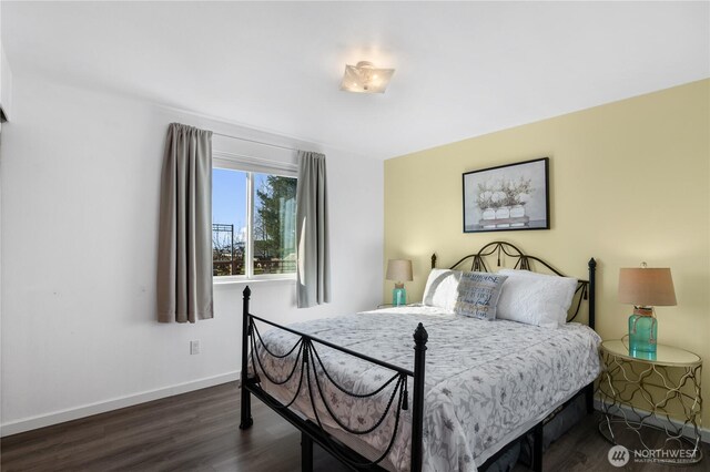 bedroom featuring dark wood finished floors and baseboards