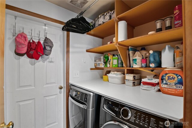 laundry room with visible vents, separate washer and dryer, and laundry area