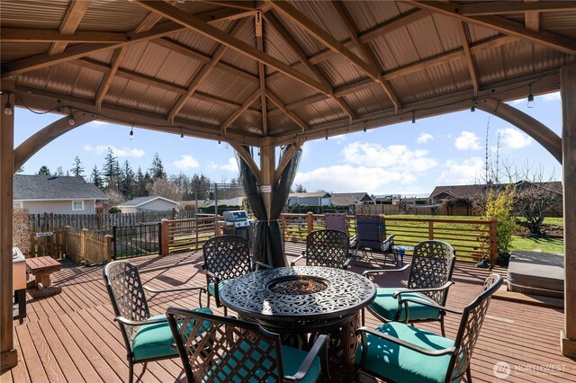 wooden terrace with a gazebo and a residential view