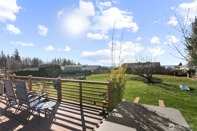 wooden terrace featuring fence private yard and a yard