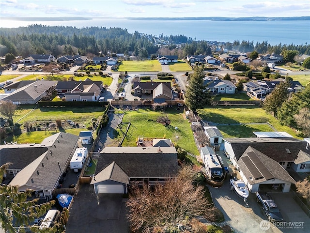 drone / aerial view featuring a residential view and a water view