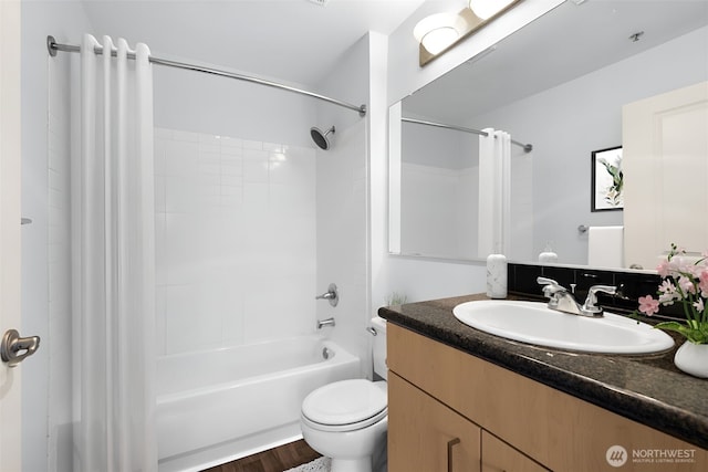 bathroom with vanity, toilet, and shower / bath combo with shower curtain