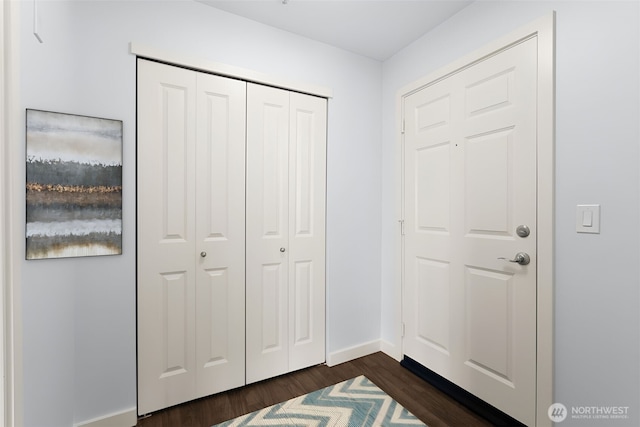 entrance foyer with dark wood-style floors and baseboards