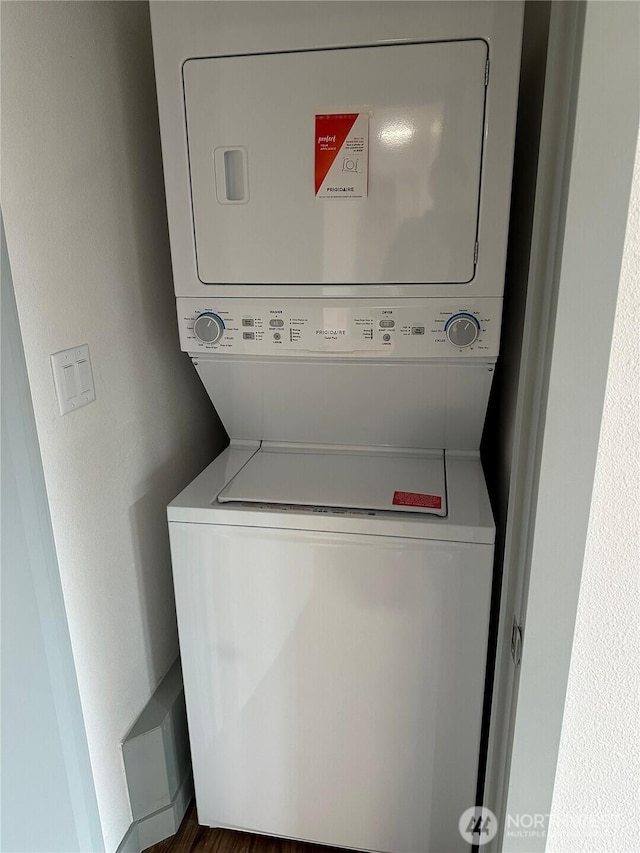 laundry room with laundry area and stacked washer / dryer