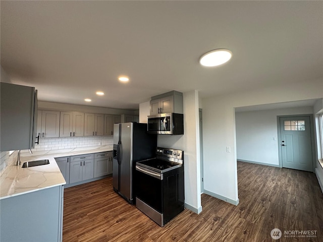 kitchen with black / electric stove, gray cabinetry, a sink, refrigerator with ice dispenser, and stainless steel microwave