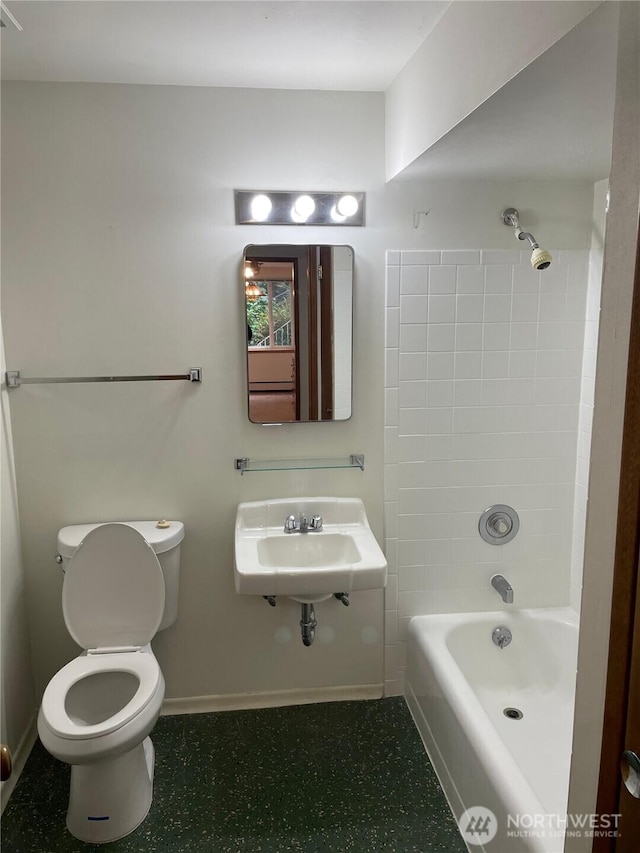 full bath with toilet, shower / bath combination, baseboards, and a sink