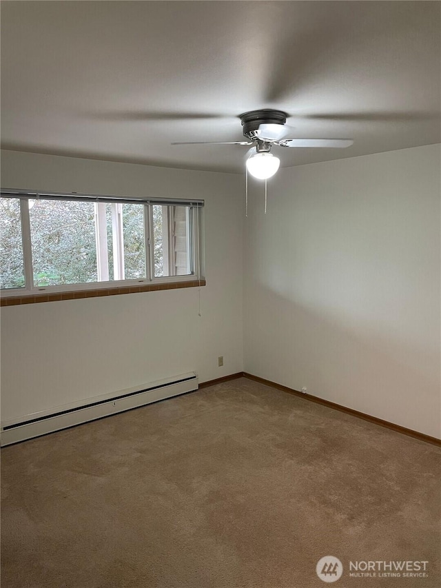 carpeted spare room featuring baseboards, ceiling fan, and baseboard heating