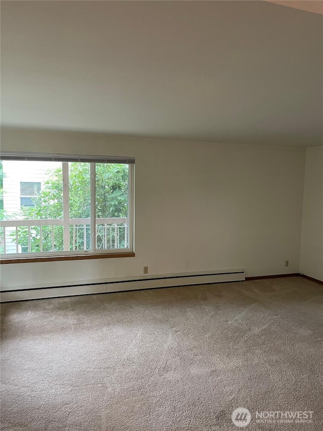 unfurnished room featuring a baseboard radiator and carpet flooring