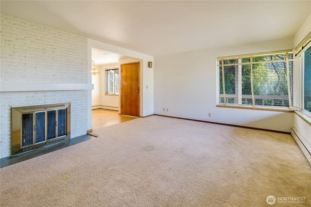 unfurnished living room featuring a baseboard heating unit, carpet floors, a brick fireplace, and baseboards