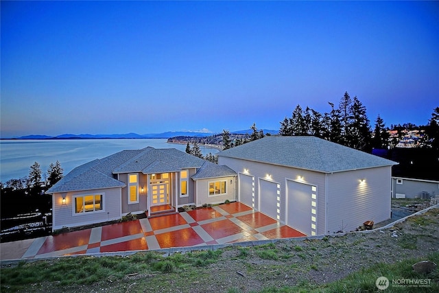 view of front of property with a garage, french doors, and a mountain view