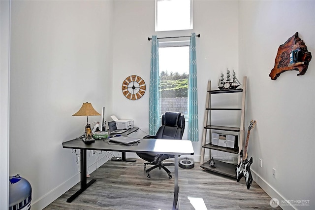 home office featuring wood finished floors and baseboards